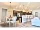 Modern kitchen with stainless steel appliances, island seating, and open dining area perfect for entertaining at 6686 Treymont Dr, Lakeland, FL 33813