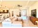 Comfortable living room with a plush sofa, television, and open layout adjacent to the modern kitchen at 6686 Treymont Dr, Lakeland, FL 33813