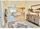 Open-concept living room with modern decor, leading to the kitchen and outdoor patio at 6686 Treymont Dr, Lakeland, FL 33813