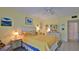 Comfortable bedroom with yellow accents, a ceiling fan, and a door leading to closet space at 717 S Beach St # 205C, Daytona Beach, FL 32114