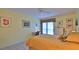 Bright bedroom with a queen bed, neutral tile flooring, desk, and a large window at 717 S Beach St # 205C, Daytona Beach, FL 32114