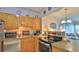 Well-maintained kitchen with wood cabinets, stainless steel appliances, and views to the living room at 717 S Beach St # 205C, Daytona Beach, FL 32114
