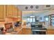 Kitchen area overlooking the living room, featuring updated appliances and ample counter space at 717 S Beach St # 205C, Daytona Beach, FL 32114