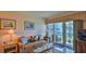 Bright living room, featuring a comfortable seating area and sliding doors to the porch at 717 S Beach St # 205C, Daytona Beach, FL 32114