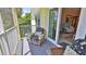 Comfortable seating on a screened porch, with a view to the outdoors at 717 S Beach St # 205C, Daytona Beach, FL 32114