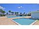 Community pool area with a shallow pool for children and mature palm trees surrounding the pool at 717 S Beach St # 205C, Daytona Beach, FL 32114