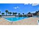A large pool with beautiful, clear water with palm trees surrounding the pool in a community at 717 S Beach St # 205C, Daytona Beach, FL 32114