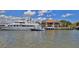 Waterfront restaurant boasts outdoor seating, fueling dock, and boats along the pier under sunny skies at 717 S Beach St # 205C, Daytona Beach, FL 32114