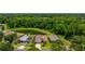 Aerial view of homes with mature trees and a pond in the backyard at 7233 Mystic Brook Way, Davenport, FL 33896