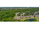 Aerial view of residential area and pond with lush trees at 7233 Mystic Brook Way, Davenport, FL 33896