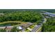 Aerial view of a neighborhood, with houses, backyard pond, mature trees, and lush landscaping at 7233 Mystic Brook Way, Davenport, FL 33896