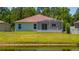 View of backyard featuring screened-in porch overlooking a pond and lush greenery at 7233 Mystic Brook Way, Davenport, FL 33896