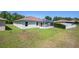 Home's backyard features a screened-in porch and pond at 7233 Mystic Brook Way, Davenport, FL 33896