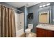 Bathroom with a shower and tub combination, toilet, vanity with sink, and vanity lights at 7233 Mystic Brook Way, Davenport, FL 33896