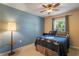Bedroom with a ceiling fan, window with curtains, and a Star Wars themed bed spread and pillow at 7233 Mystic Brook Way, Davenport, FL 33896