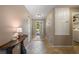 Bright foyer featuring tile flooring, a console table, and a view of the front door at 7233 Mystic Brook Way, Davenport, FL 33896
