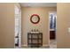 Inviting hallway with a decorative mirror, console table, and doorways to the bedroom and bathroom at 7233 Mystic Brook Way, Davenport, FL 33896