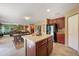 Open-concept floorplan featuring a kitchen island with seating flowing into the living area at 7233 Mystic Brook Way, Davenport, FL 33896