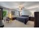 Serene main bedroom features soft natural light, a ceiling fan, and a neutral color palette at 7233 Mystic Brook Way, Davenport, FL 33896