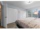 Bright bedroom featuring wood floors, a closet, and natural light, creating a cozy atmosphere at 758 E Michigan St # 208, Orlando, FL 32806
