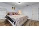 Spacious bedroom with wood floors, a cozy bed, and light-filled windows at 758 E Michigan St # 208, Orlando, FL 32806
