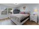 Bright bedroom with wood floors, large window, neutral walls, and comfortable furnishings at 758 E Michigan St # 208, Orlando, FL 32806