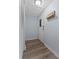 Clean entryway featuring a white door, wood-look flooring, and a decorative wall rack at 758 E Michigan St # 208, Orlando, FL 32806