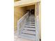 Exterior staircase leading to the condo units with a painted wood structure and natural light at 758 E Michigan St # 208, Orlando, FL 32806