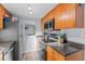 Galley kitchen with stainless steel appliances and hardwood cabinets at 758 E Michigan St # 208, Orlando, FL 32806