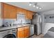 Compact kitchen featuring stainless steel appliances and light wood cabinets at 758 E Michigan St # 208, Orlando, FL 32806