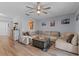 Cozy living room with a fan, natural light, and an open view to the kitchen at 758 E Michigan St # 208, Orlando, FL 32806