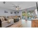 Bright living room with sliding glass doors to a screened patio and pool view at 758 E Michigan St # 208, Orlando, FL 32806
