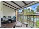 Cozy patio with comfortable seating, string lights, and views of the community pool and tropical surroundings at 758 E Michigan St # 208, Orlando, FL 32806