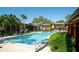 Inviting community pool with ample space for relaxation and leisure surrounded by tropical greenery at 758 E Michigan St # 208, Orlando, FL 32806