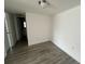 Bedroom with light-colored hard surface floor and view into bathroom at 7604 Forest City Rd # 11, Orlando, FL 32810