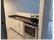 Bright kitchen with white cabinetry, stainless steel appliances, and modern countertops at 7604 Forest City Rd # 11, Orlando, FL 32810