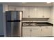 Bright kitchen with white cabinetry, stainless steel appliances, and modern countertops at 7604 Forest City Rd # 11, Orlando, FL 32810