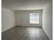 Open-concept living room with window and a light-colored hard surface floor at 7604 Forest City Rd # 11, Orlando, FL 32810