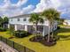 A townhome featuring a manicured backyard with palm trees and a fenced in outdoor living space at 772 Driving Range Ct, Kissimmee, FL 34747