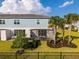 A home backyard featuring a covered patio, lush green lawn, and privacy fence at 772 Driving Range Ct, Kissimmee, FL 34747
