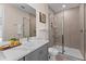 Modern bathroom with a glass-enclosed shower, sleek vanity, and neutral tile at 772 Driving Range Ct, Kissimmee, FL 34747