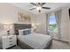 Cozy bedroom with queen bed, side tables, and a large window offering natural light at 772 Driving Range Ct, Kissimmee, FL 34747