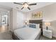 Cozy bedroom featuring a ceiling fan, closet, modern wall art, and stylish nightstands with lamps at 772 Driving Range Ct, Kissimmee, FL 34747