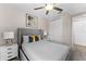Nicely decorated bedroom features closet, ceiling fan, stylish nightstands, and modern wall art at 772 Driving Range Ct, Kissimmee, FL 34747