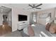 Bright bedroom featuring a ceiling fan, large windows, gray headboard, modern dresser, and access to closet at 772 Driving Range Ct, Kissimmee, FL 34747