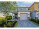 A two-story home with a garage and a well-maintained front yard at 772 Driving Range Ct, Kissimmee, FL 34747