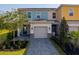 A two-story residential property featuring a garage and landscaped front yard at 772 Driving Range Ct, Kissimmee, FL 34747