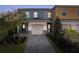 Charming two-story townhome with a well-manicured front yard and a paved driveway leading to an attached garage at 772 Driving Range Ct, Kissimmee, FL 34747