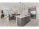 Spacious kitchen featuring an island with pendant lighting open to dining and living rooms, creating a harmonious flow at 772 Driving Range Ct, Kissimmee, FL 34747