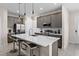 Modern kitchen with stainless steel appliances, gray cabinets, island and quartz countertop at 772 Driving Range Ct, Kissimmee, FL 34747